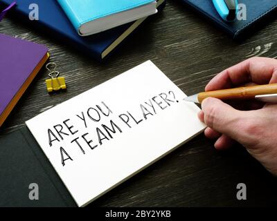 Man writes Are You a Team Player question. Teamwork concept. Stock Photo
