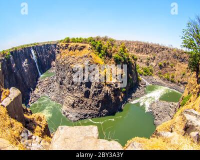 Victoria Falls on Zambezi River. Dry season. Border between Zimbabwe and Zambia, Africa. Fisheye shot. Stock Photo