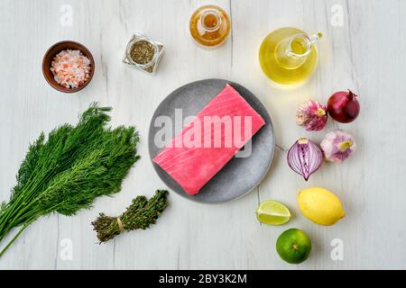 Top view of raw tuna fillet in plate with spice Stock Photo