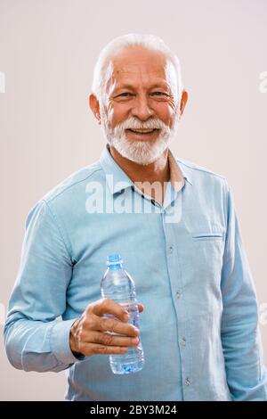 Man holding with bottle of water isolated on white background Stock ...