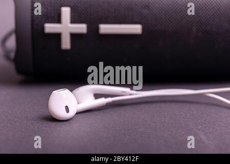 Close-up headphone stack on black background, modern speaker earbuds device accessories. Stock Photo