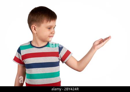 Cute kid pointing on something, isolated on white background. Stock Photo