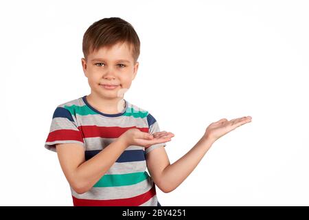 Cute kid pointing on something, isolated on white background. Stock Photo