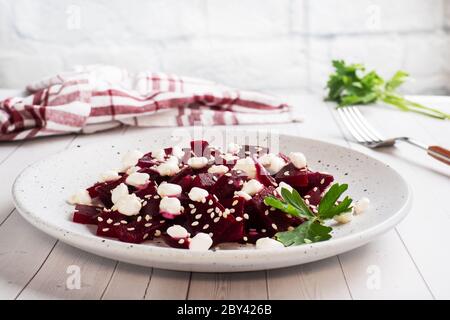 Salad of boiled beetroot and grain curd with sesame seeds on a plate Copy space Stock Photo