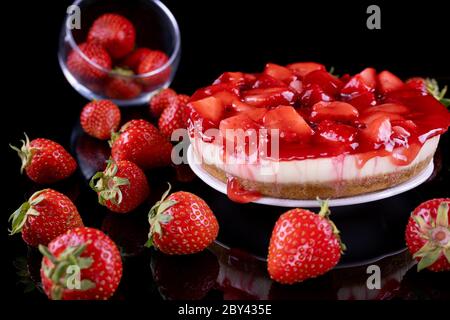 cheesecake with strawberry and fresh berries on black background Stock Photo