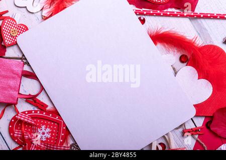 Wooden white background with red hearts and gifts. The concept of Valentine Day whith empty blank for text. Top view copy space. Stock Photo