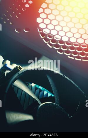 A cooling system of PC. A fan of central processing or the CPU on motherboard cooler pc system unit. Lens glare and toned photo Stock Photo