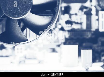 CPU cooler of processor on motherboard. Computer circuit board and CPU cooling fans inside a PC for background. Toned photo Stock Photo