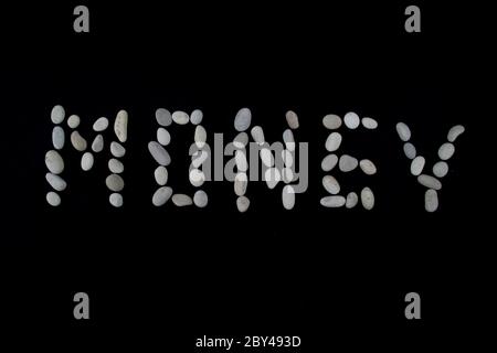 Money text on black color background with copy space using with stones Stock Photo