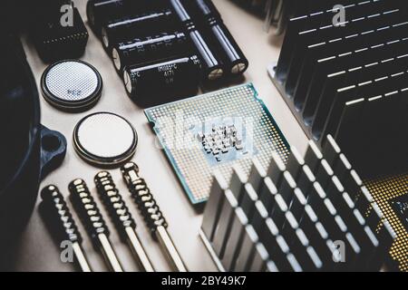 Computer and laptop hardware - CPU, fan cooler, battery, capacitors, radiator, chip. PC Repair, assembly, engineering background Stock Photo