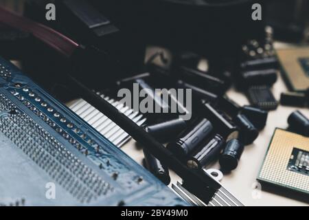 Computer and laptop hardware - CPU, fan cooler, battery, capacitors, radiator, chip. PC Repair, assembly, engineering background Stock Photo