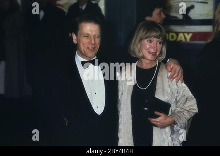 English actor Edward Fox accompanied by his wife actress Joanna David. attend the premier of the film 'Return from the River Kwai'. London. England. UK. 1989 Stock Photo