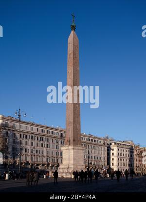 The ancient Egyptian obelisk in front of the Basilica of St John Lateran on a clear winter day. Tourists are walking in front of the obelisk base. Stock Photo