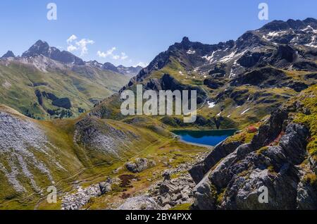 The Lac Bleu in Chianale, mountain lake in the italian alps of Cuneo, Piedmont, facing the famous Monviso peak (mount viso) Stock Photo