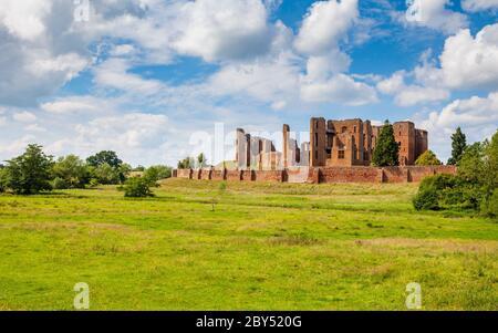 The ruins of Kenilworth Castle across the drained Great Mere in the Warwickshire countryside, England Stock Photo