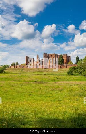 The ruins of Kenilworth Castle across the drained Great Mere in the Warwickshire countryside, England Stock Photo