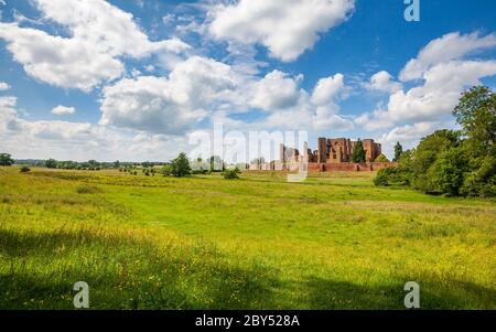 The ruins of Kenilworth Castle across the drained Great Mere in the Warwickshire countryside, England Stock Photo