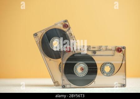 Beautiful Audio cassettes tape on a white table and yellow space.Minimalism retro style concept. 80s. Background pattern for design. Stock Photo