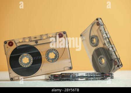 Beautiful Audio cassettes tape on a white table and yellow space.Minimalism retro style concept. 80s. Background pattern for design. Stock Photo