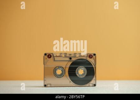 Close up Audio cassette tape on a white table and yellow space.Minimalism retro style concept. 80s. Background pattern for design. Stock Photo