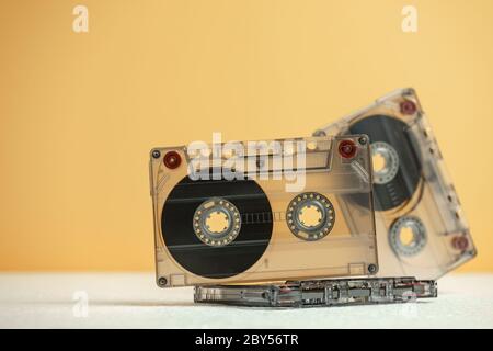 Beautiful Audio cassettes tape on a white table and yellow space.Minimalism retro style concept. 80s. Background pattern for design. Stock Photo