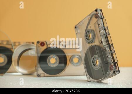 Close up Audio cassette tape on a white table and yellow space.Minimalism retro style concept. 80s. Background pattern for design. Stock Photo