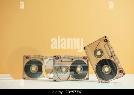 Beautiful Audio cassettes tape on a white table and yellow space.Minimalism retro style concept. 80s. Background pattern for design. Stock Photo