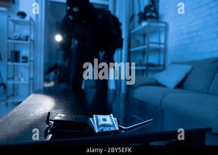 Robber breaking in an apartment ready to steal Stock Photo