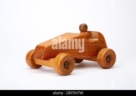 Photograph of a handmade wooden toy car with driver. Stock Photo