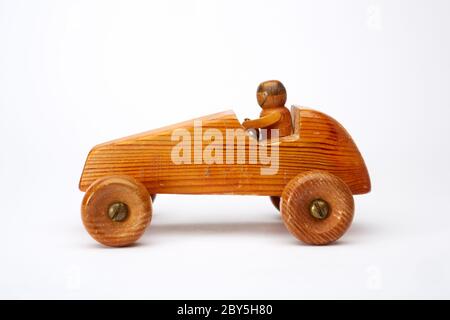 Photograph of a handmade wooden toy car with driver. Stock Photo