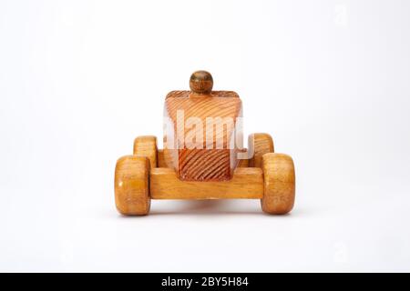Photograph of a handmade wooden toy car with driver. Stock Photo