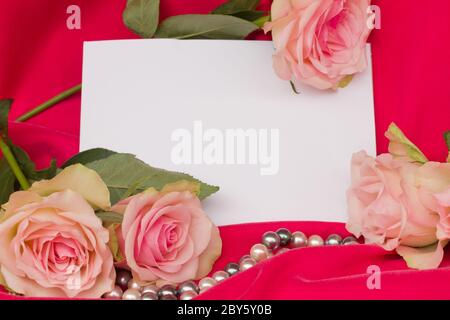 pink roses with pearls strand and blank card Stock Photo