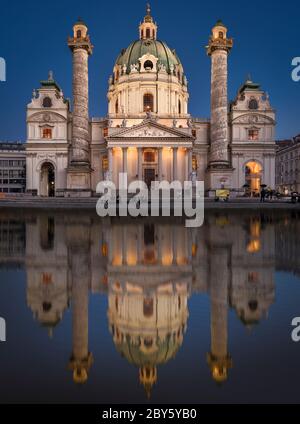 View of Karlskirche with illumination and reflection in the water, Vienna, Austria Stock Photo
