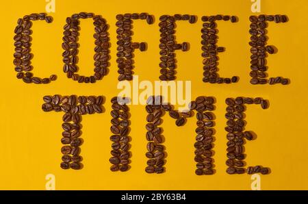 coffee beans on a yellow background, the inscription coffee time Stock Photo