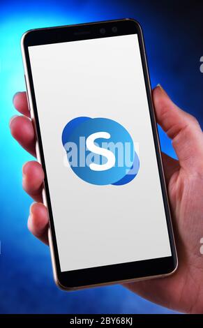 POZNAN, POL - MAY 21, 2020: Hand holding smartphone displaying logo of Skype for Business Server, part of the Office family software and services deve Stock Photo