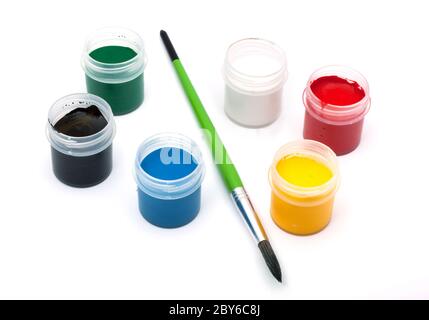 Paints with a paintbrush isolated on white background Stock Photo