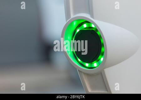 A battery charging point for electric cars, illuminated with green LEDs, in the area of the Retiro district, in Madrid, Spain. Stock Photo