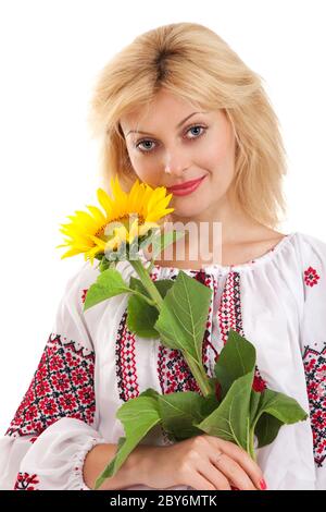 Woman wears Ukrainian dress is holding a sunflower Stock Photo