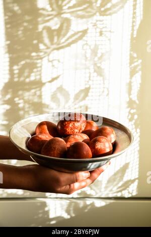 Red easter eggs on a plate. Stock Photo
