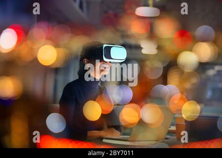 Smiling businesswoman using virtual reality glasses Stock Photo