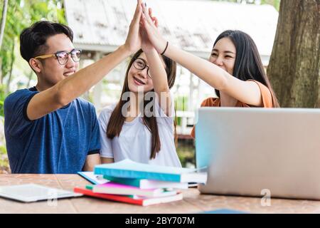 Closeup photo Education Students College putting their hands show on coordinate of each other Stock Photo