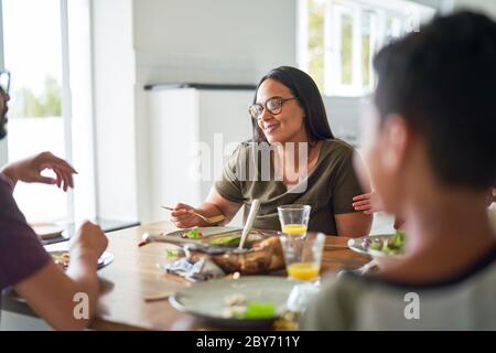 Happy family eating dinner at table Stock Photo