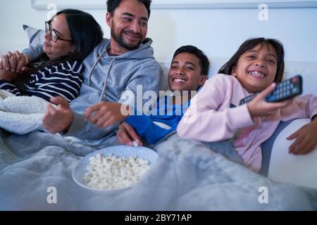 Family watching TV on sofa Stock Photo