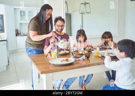 Family eating lunch at dining table Stock Photo