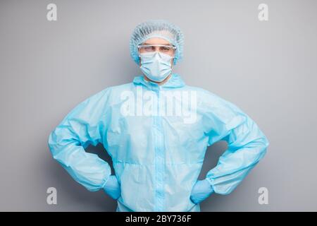 Photo of confident guy expert virologist doc center clinic arms by sides professional wear face mask hazmat blue uniform suit plastic facial goggles Stock Photo