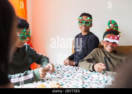 Portrait festive brothers wearing Christmas glasses Stock Photo