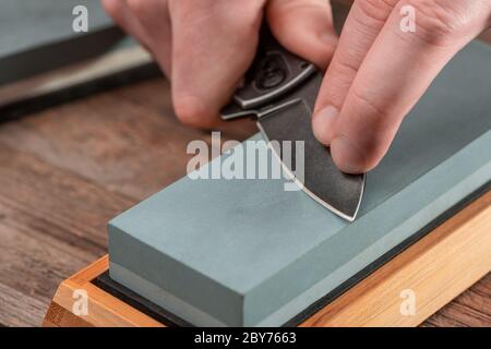 Sharpen the pocket knife with grindstone or whetstone. Pocket