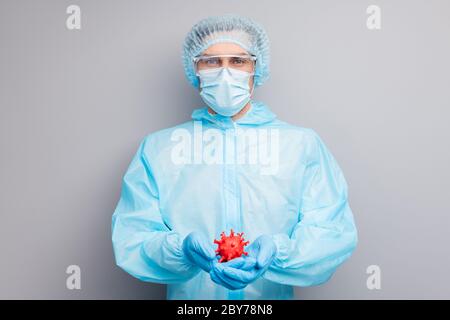 Photo of guy expert doc virology center hold covid bacteria hands vaccine research wear mask hazmat blue uniform surgical cap suit plastic facial Stock Photo