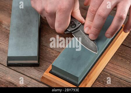 Man Using a Whetstone To Sharp His Pocket Knife Stock Image - Image of  instrument, dull: 186242253