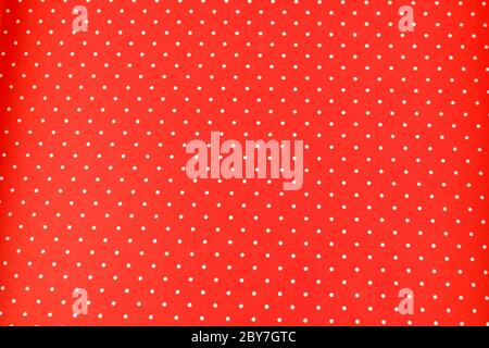 White dots over red Polka dot fabric background and texture. Seamless white and red polka dot background Stock Photo